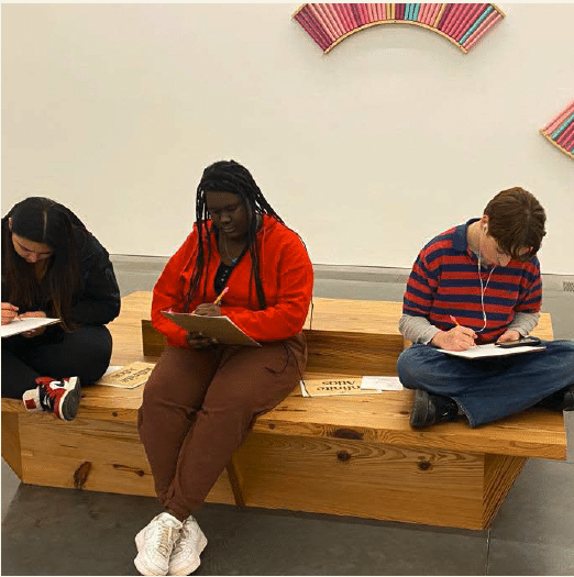 Students sitting down and writing on paper